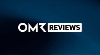 A minimalist logo on a dark blue background reads “OMR REVIEWS” in white capital letters. A diagonal stripe of lighter blue is visible behind the text.